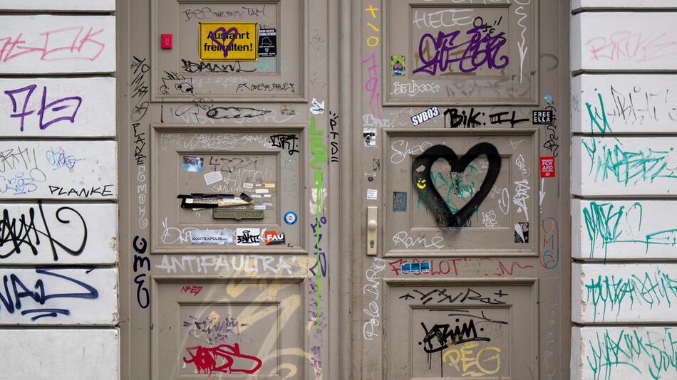 Eine Haustür ist mit Graffiti beschmiert