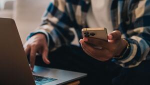 Ein Mann mit Smartphone und Laptop