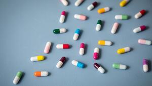 Unterschiedlich farbige Tabletten liegen auf einem Tisch