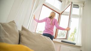 Eine Frau öffnet ein Fenster