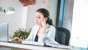 Eine Frau sitzt erschöpft vor einem Laptop