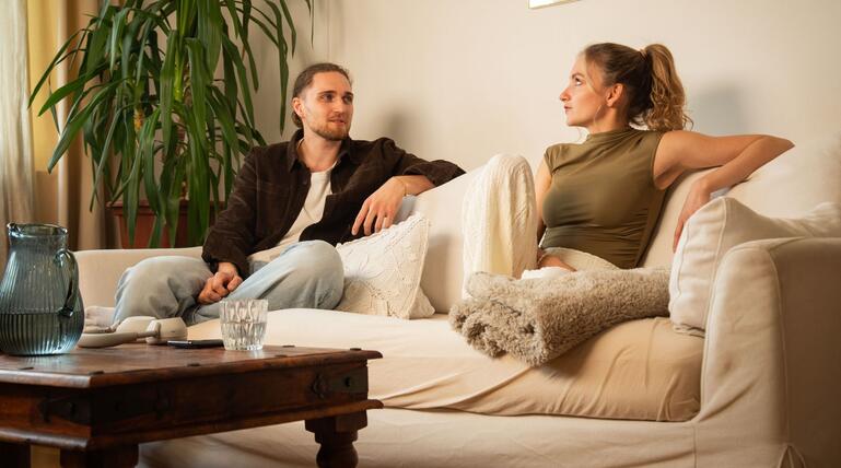 Ein Mann und eine Frau sitzen auf einem Sofa