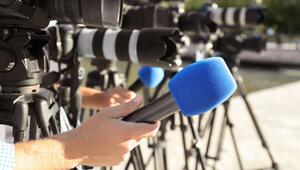 Journalists with microphones and video cameras outdoors, closeup
