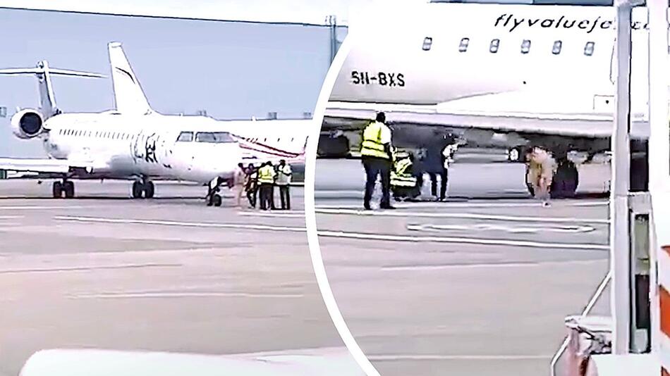Aufgepasst: Bodenpersonal duckt sich knapp vor Flugzeugflügel