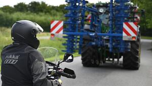 Motorradfahrer hinter landwirtschaftlichen Verkehr