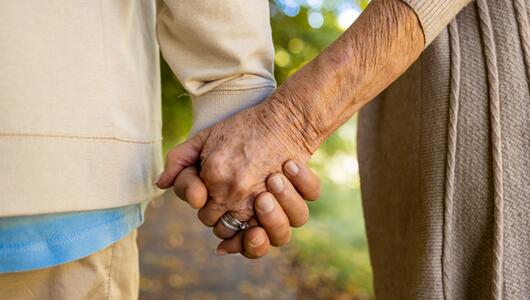 Ehepaar, das Händchen hält.