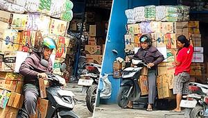 Bis zum Anschlag beladen: Rollerfahrer kämpft mit turmhohen Kartons