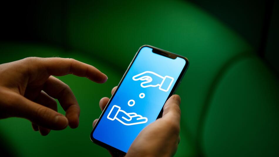 Ein Mann verwende ein Smartphone zum Geldverkehr